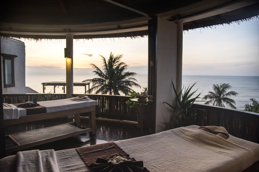 Espaço de massagem com vista para o mar ao pôr do sol